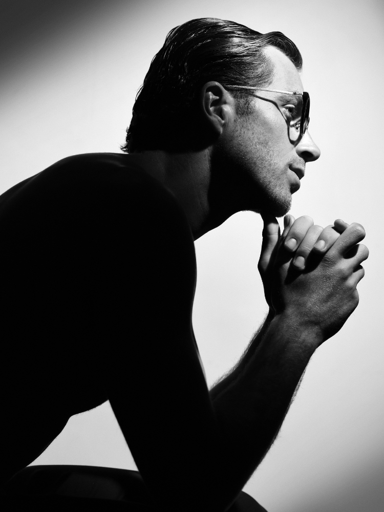 A black and white photo of a man wearing sunglasses