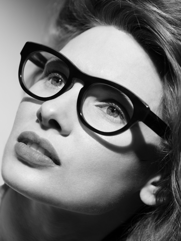 A black and white photo of a woman wearing glasses