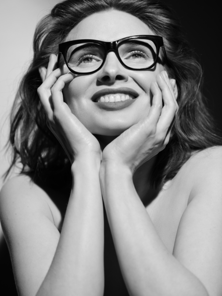 A black and white photo of a woman wearing glasses