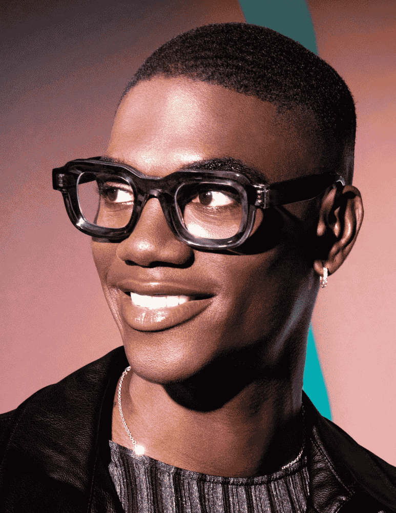A close up of a man wearing glasses and smiling.