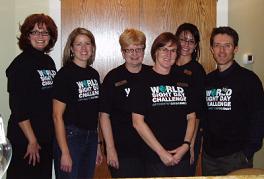 A group of people wearing black shirts that say world sight day challenge are posing for a picture.