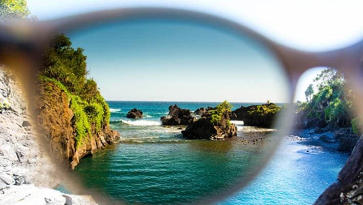 A pair of sunglasses looking out over a body of water.