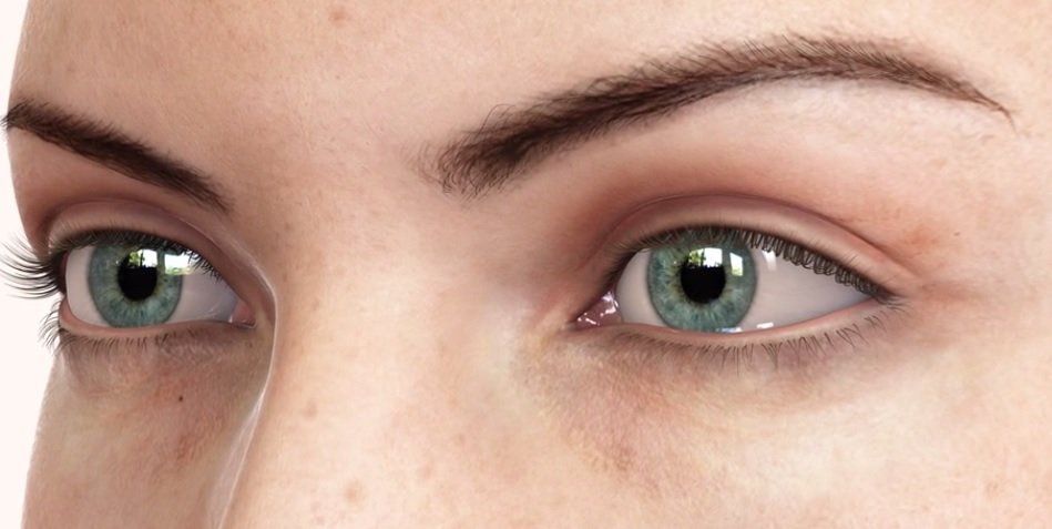 A close up of a woman 's green eyes with freckles.