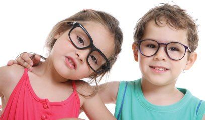 A boy and a girl wearing glasses are standing next to each other.
