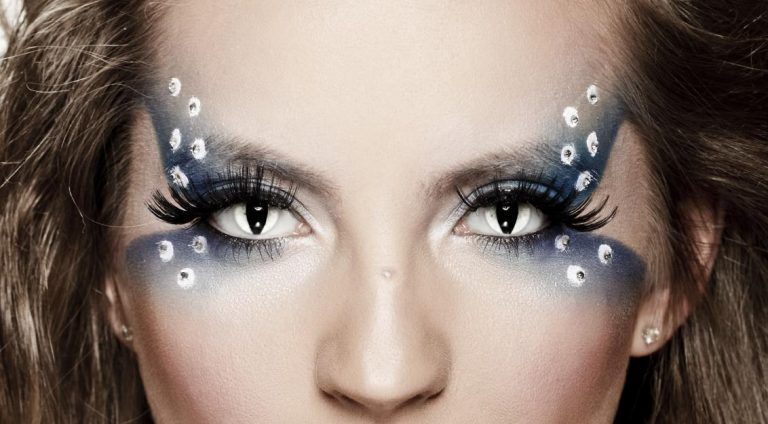 A close up of a woman 's face with makeup on it.
