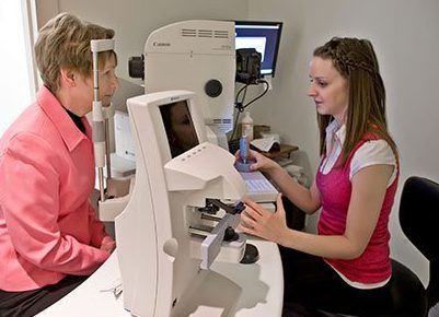 A woman is getting her eyes checked by an ophthalmologist.
