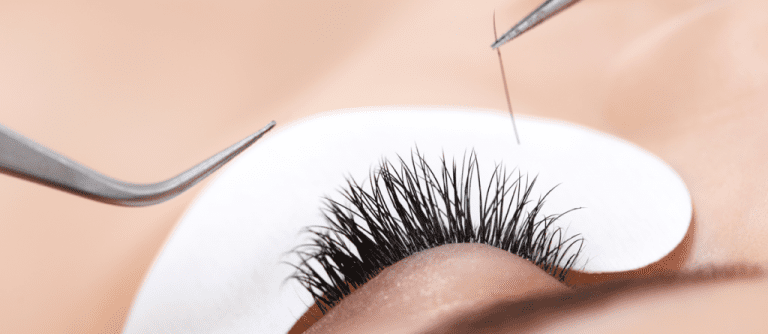 A close up of a person getting eyelash extensions.