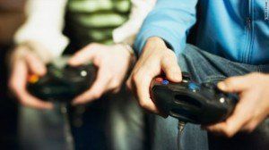 Two people are playing a video game with controllers in their hands.