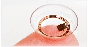 A close up of a contact lens on a finger.