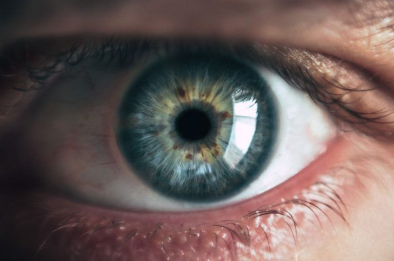A close up of a person 's blue eye.