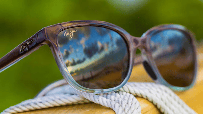 A pair of sunglasses sitting on top of a rope.