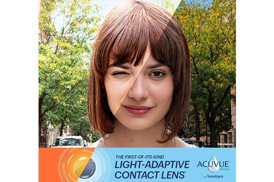 A woman is wearing a pair of light adaptive contact lenses.