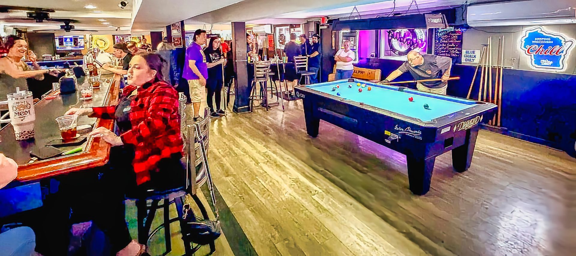 Pool and bar activity inside Ralph's Ace of Hearts