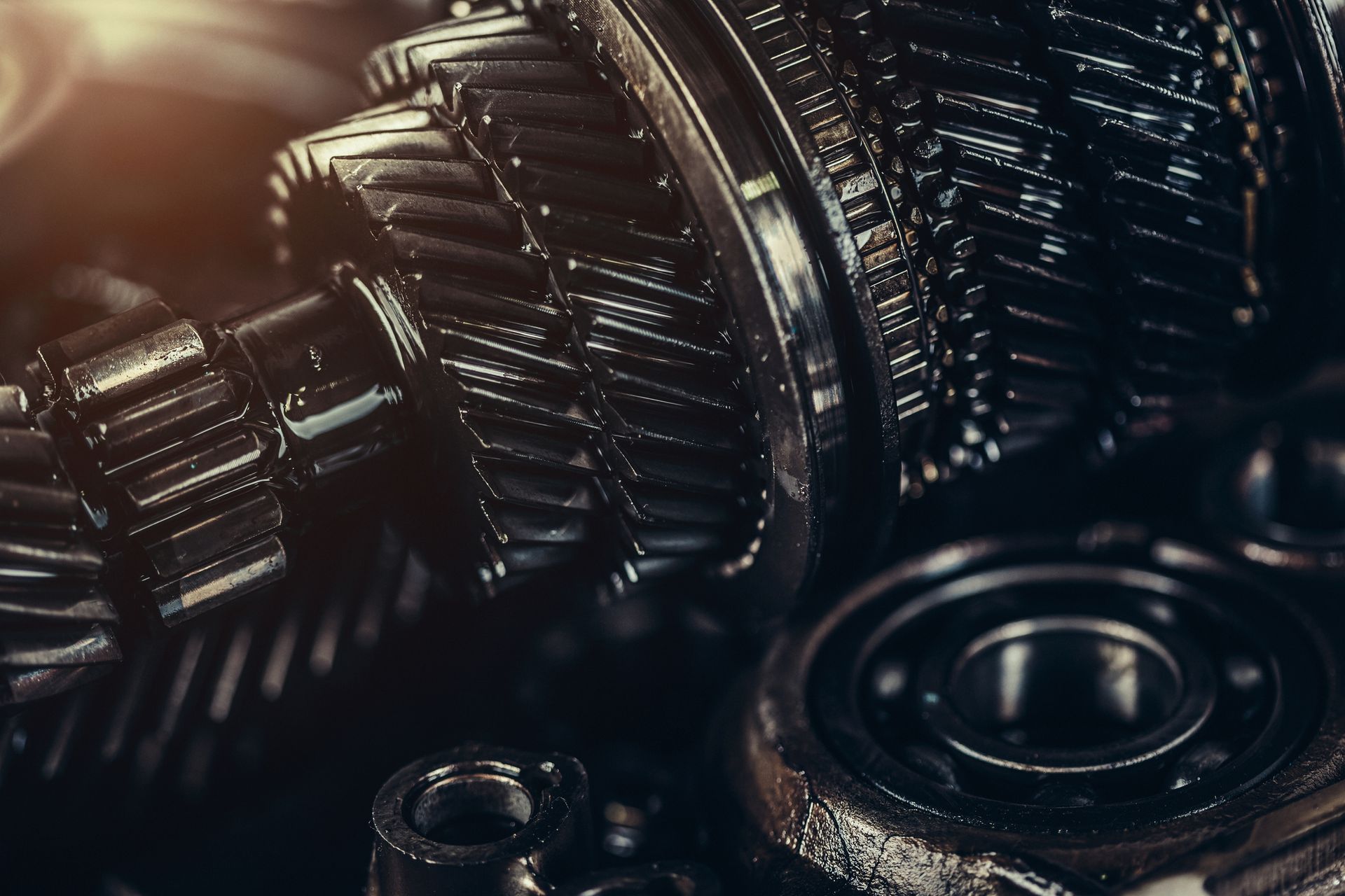 A close up of a gearbox with nuts and bearings.
