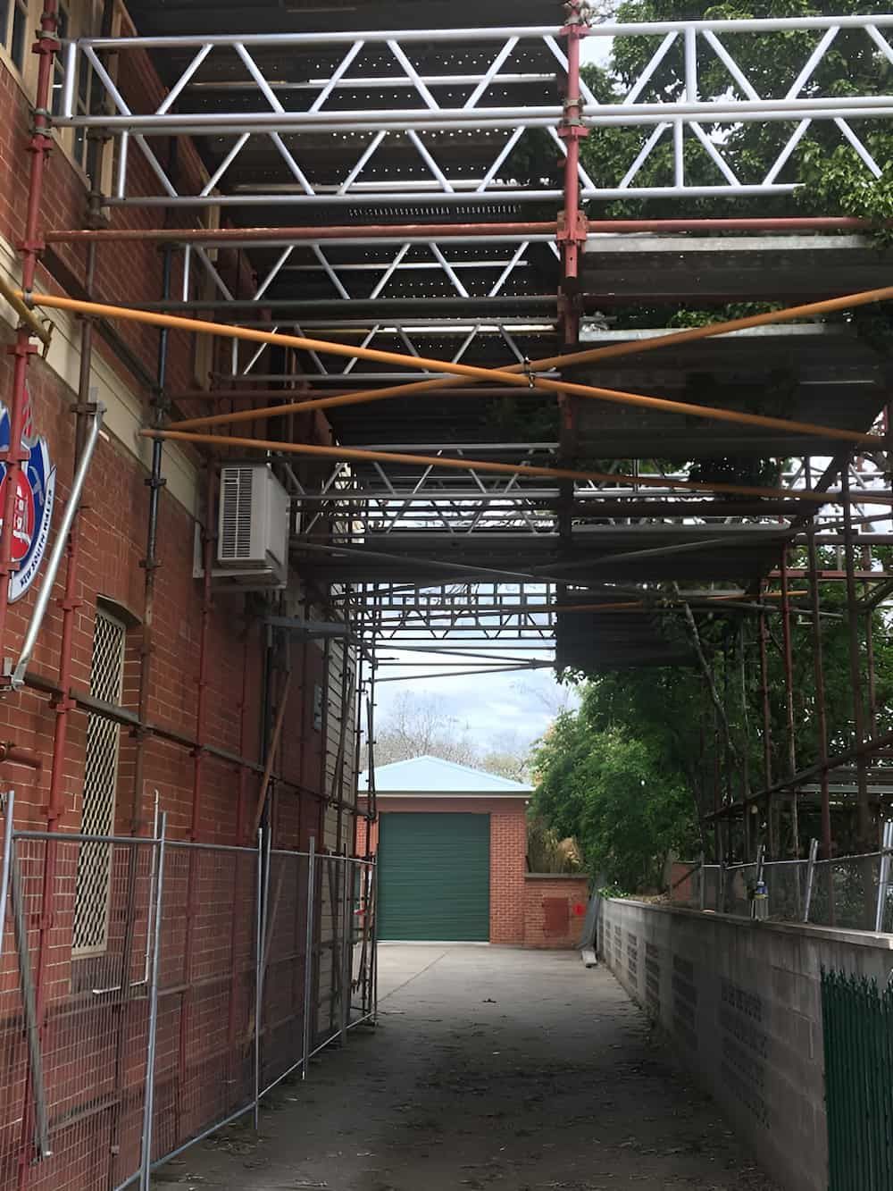 A Brick Building with Scaffolding — Big River Scaffolding Solutions Pty Ltd in Grafton, NSW