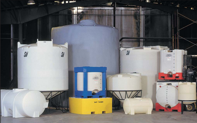 A bunch of plastic tanks are lined up in a warehouse