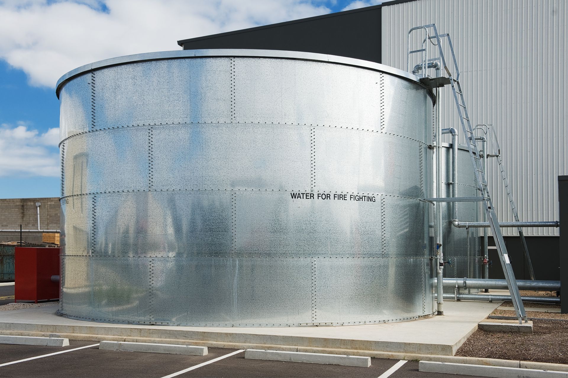 A large metal tank with a ladder attached to it