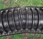A close up of a tire sitting on top of a grass covered field.