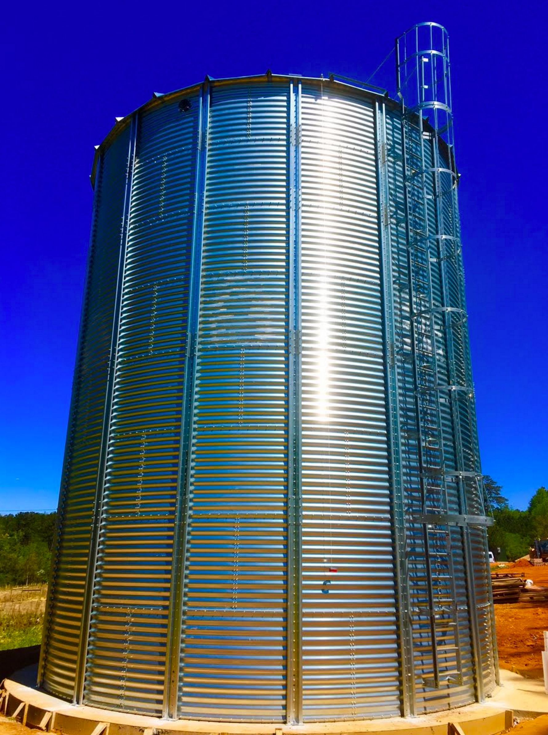 A large metal tower with a ladder on top of it.