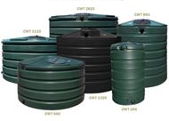 A group of green and black water tanks are stacked on top of each other.