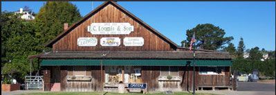 A large wooden building with a green awning on the side