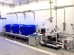 A room with a lot of pipes and tanks in it.