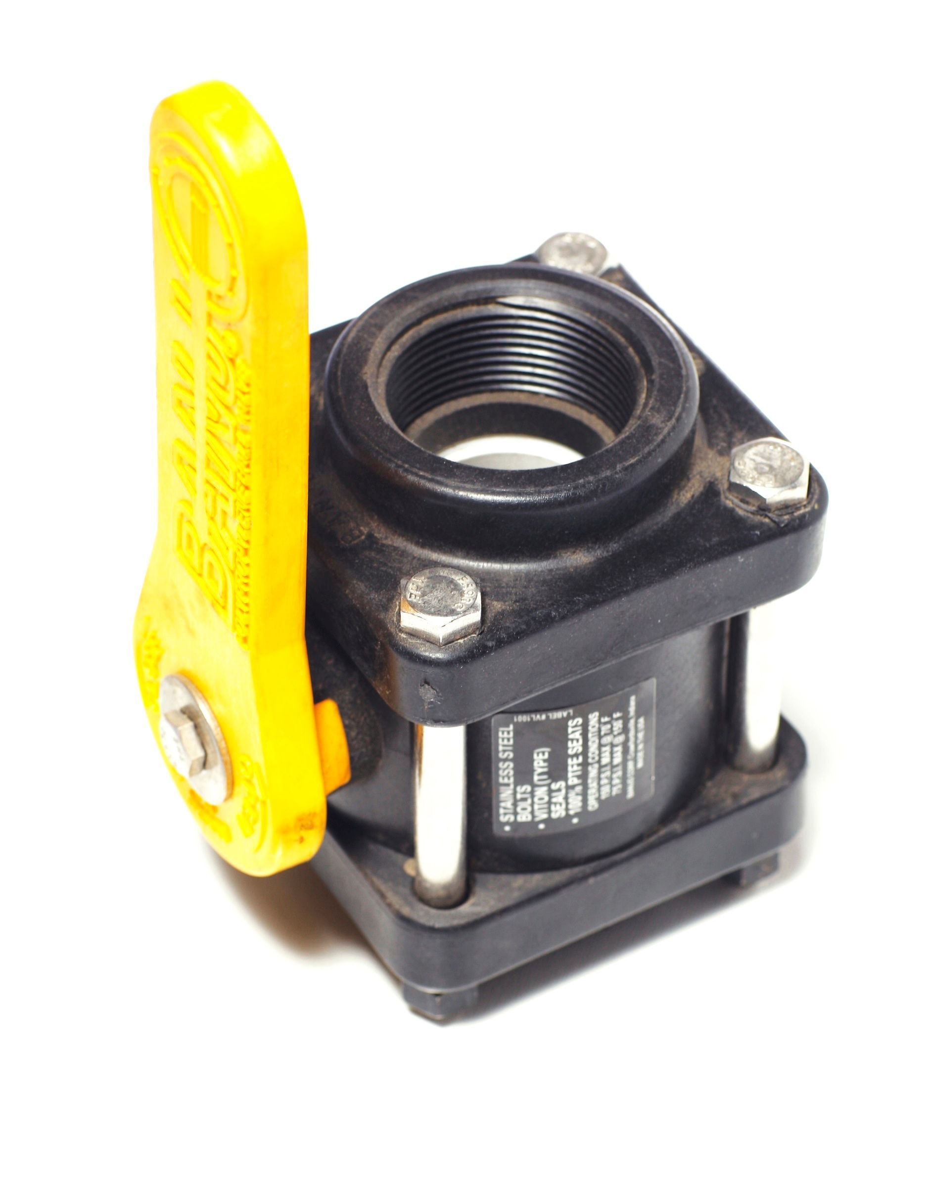 A close up of a ball valve with a yellow handle