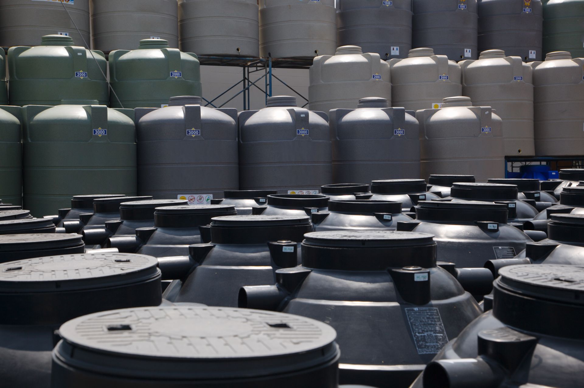 A warehouse filled with lots of plastic tanks
