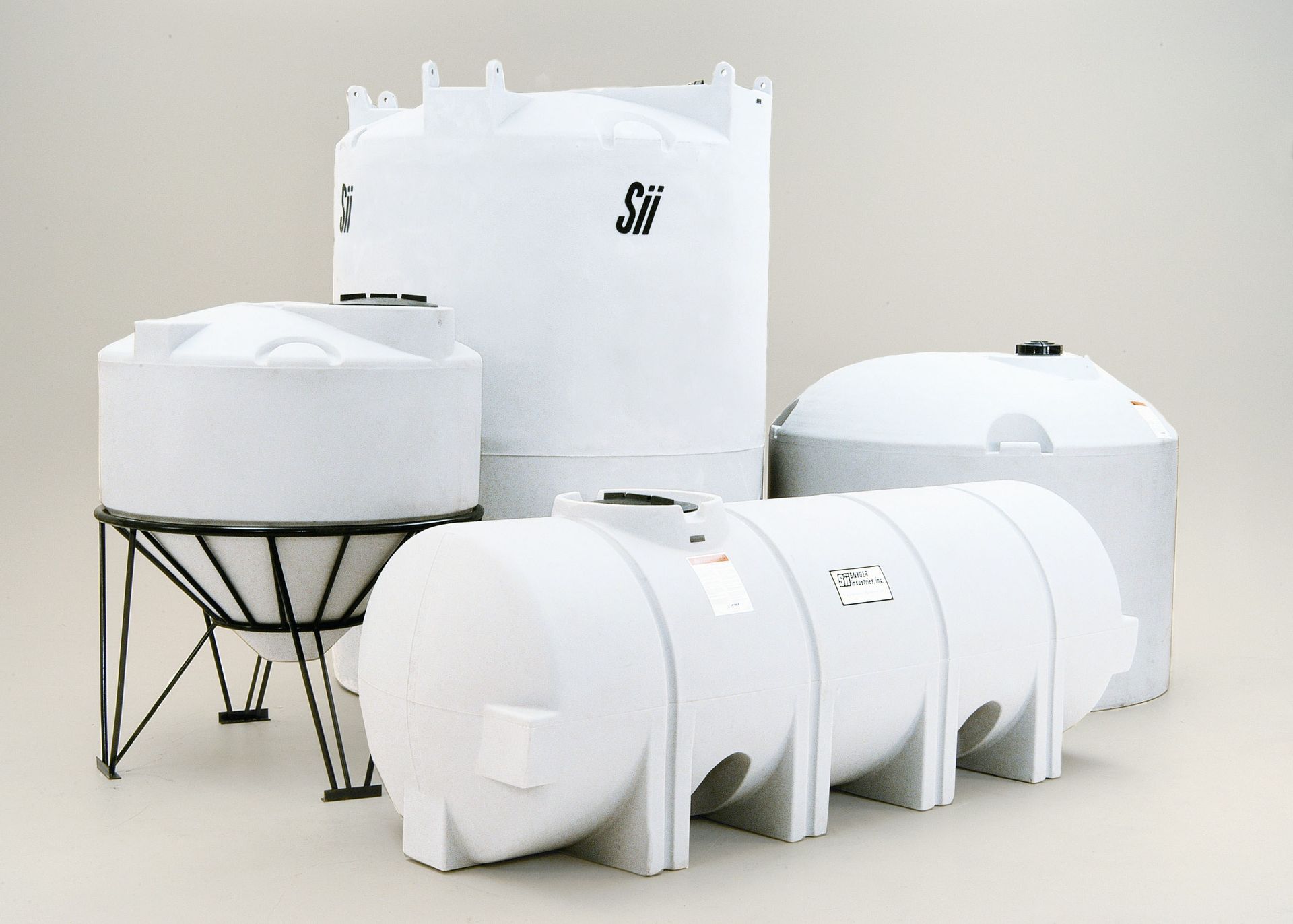 A group of white tanks with the letter s on them