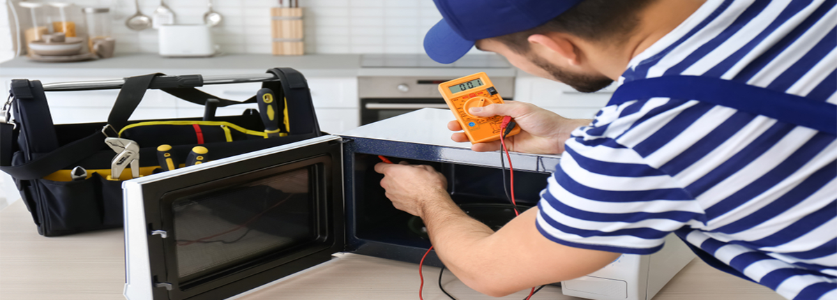 person repairing microwave