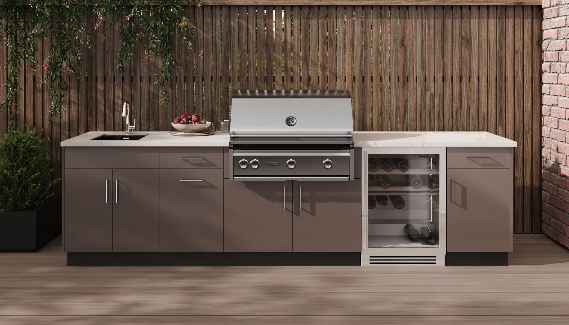 An outdoor kitchen with a grill , sink , and refrigerator.