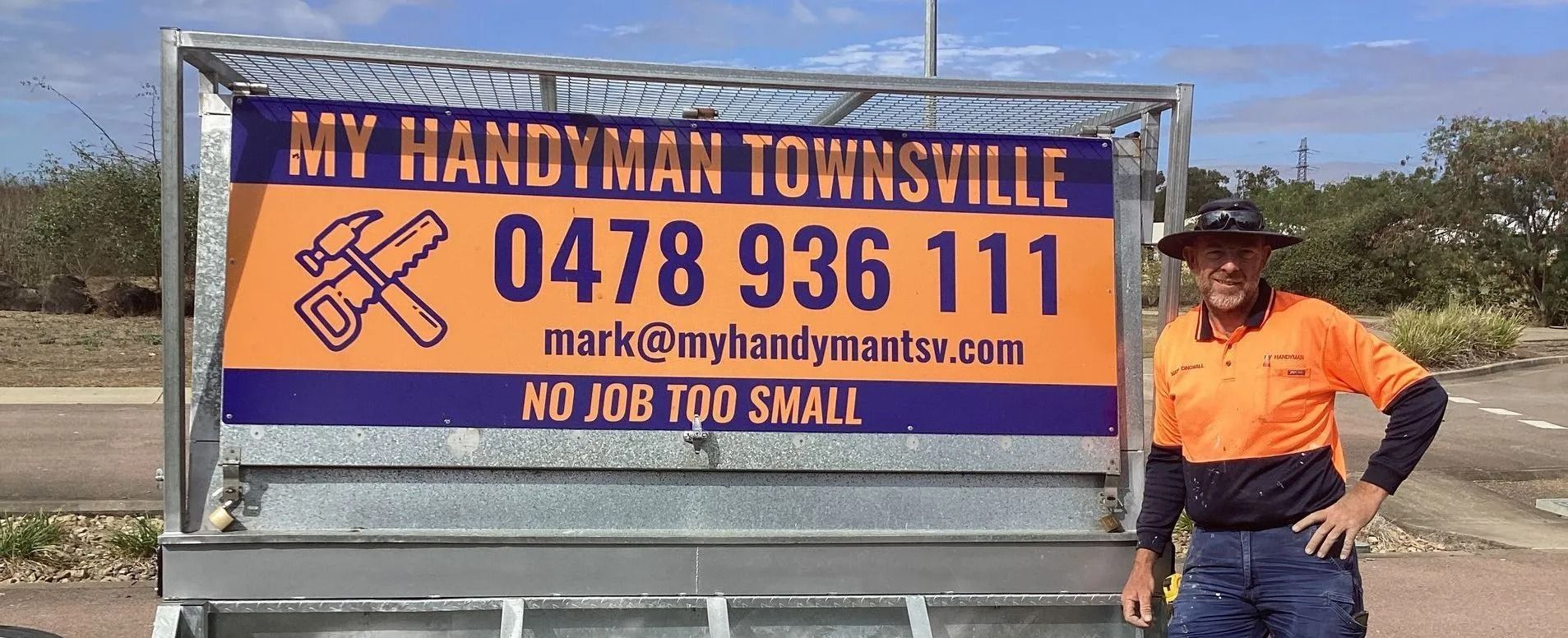 A Man in Work Clothes Stands — My Handyman Townsville In Garbutt, QLD