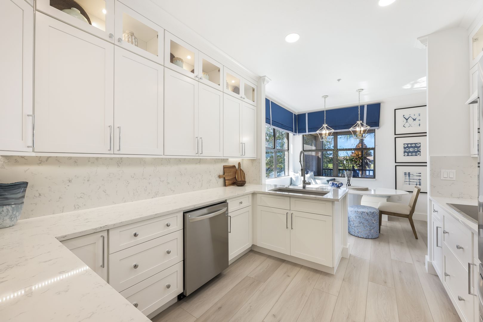 A kitchen with white cabinets and stainless steel appliances.