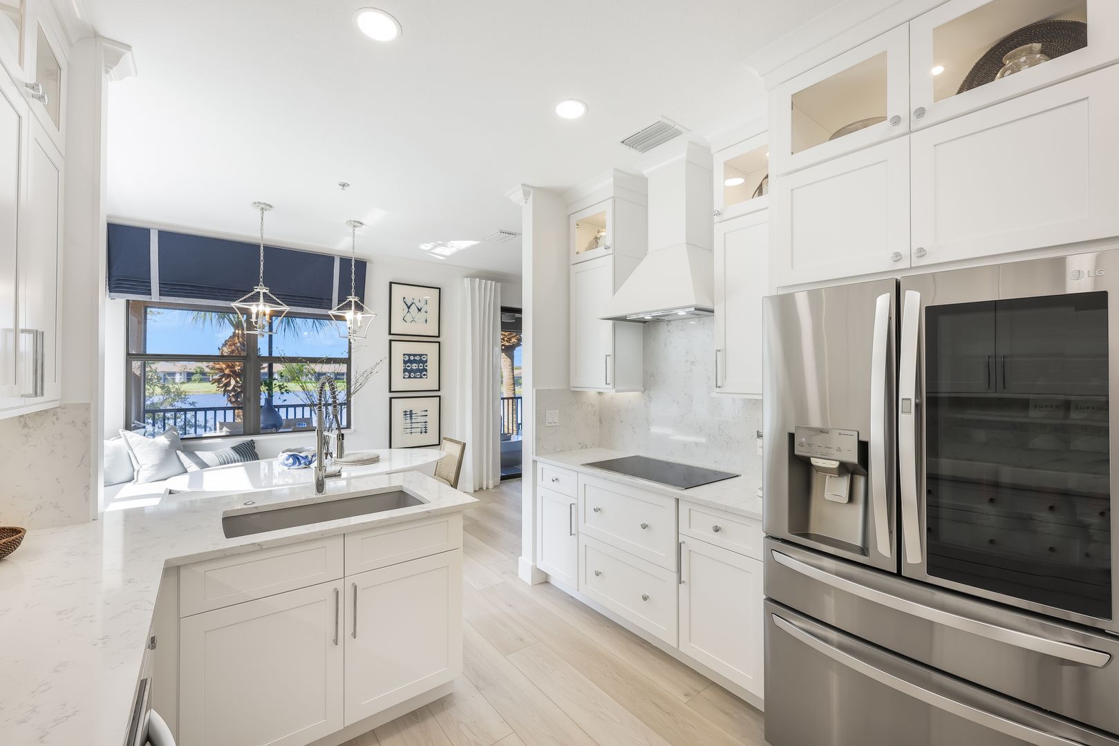 A kitchen with white cabinets and stainless steel appliances.
