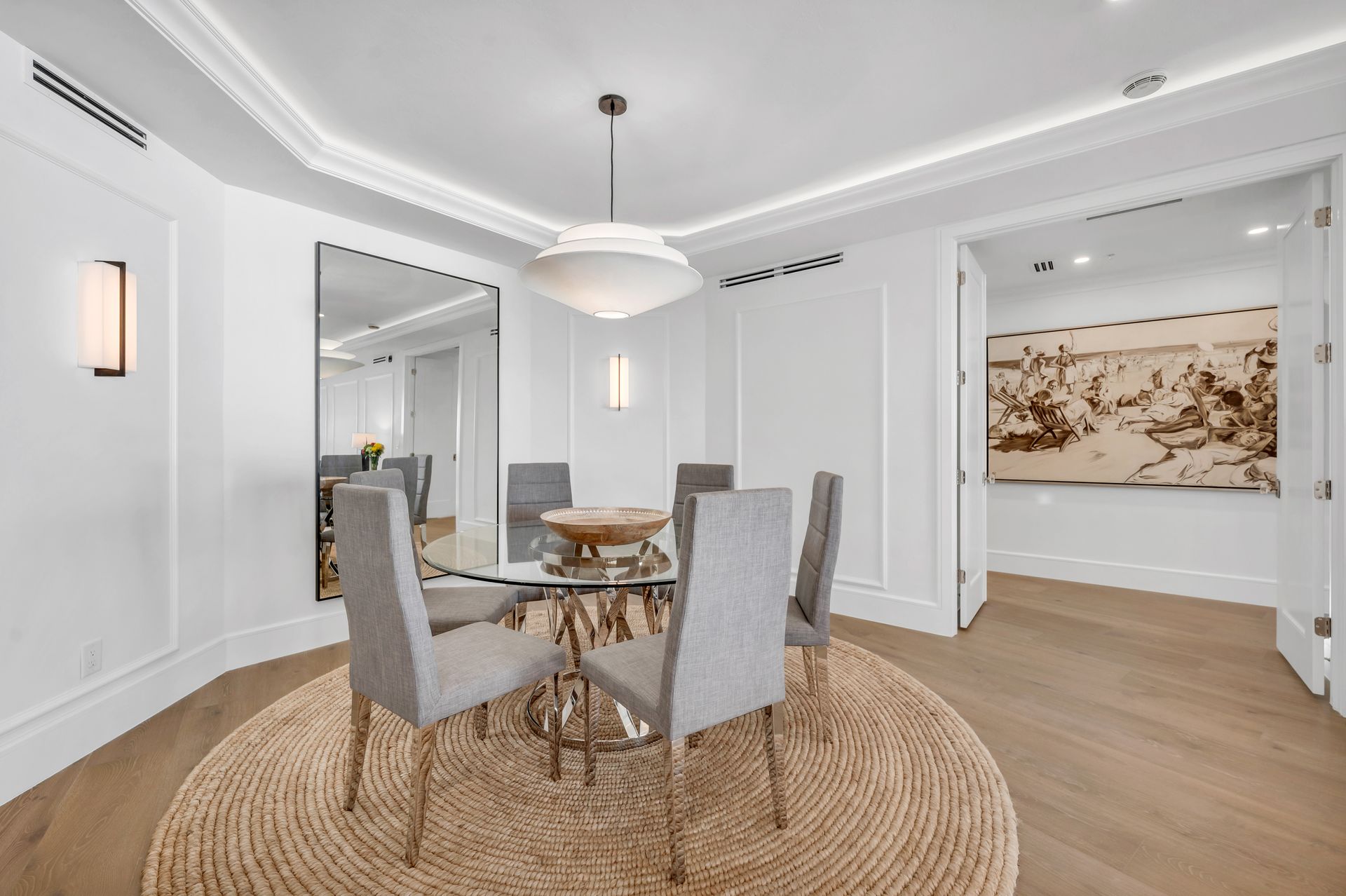 a dining room with a round table and chairs and a rug .