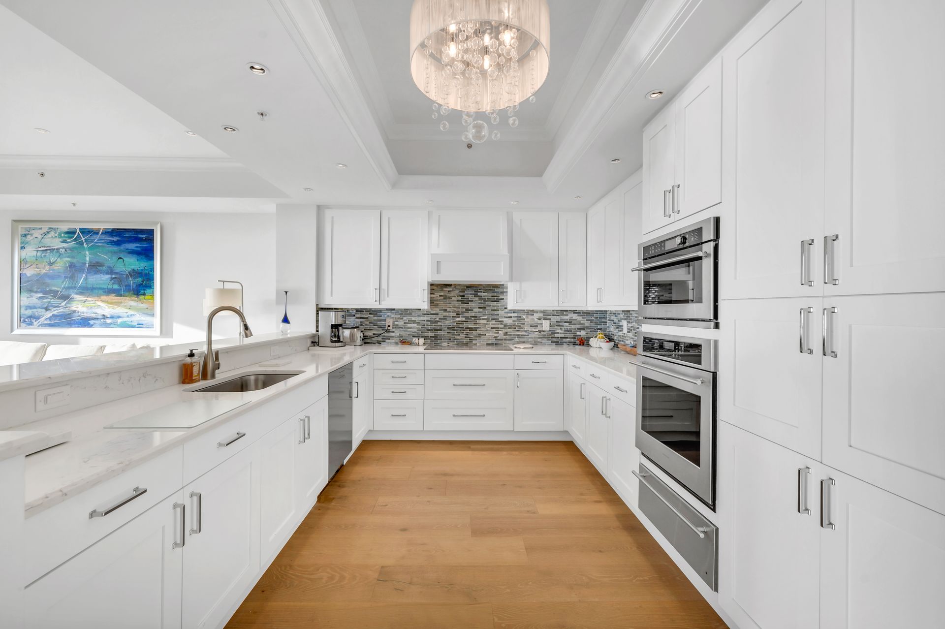 A kitchen with white cabinets and stainless steel appliances