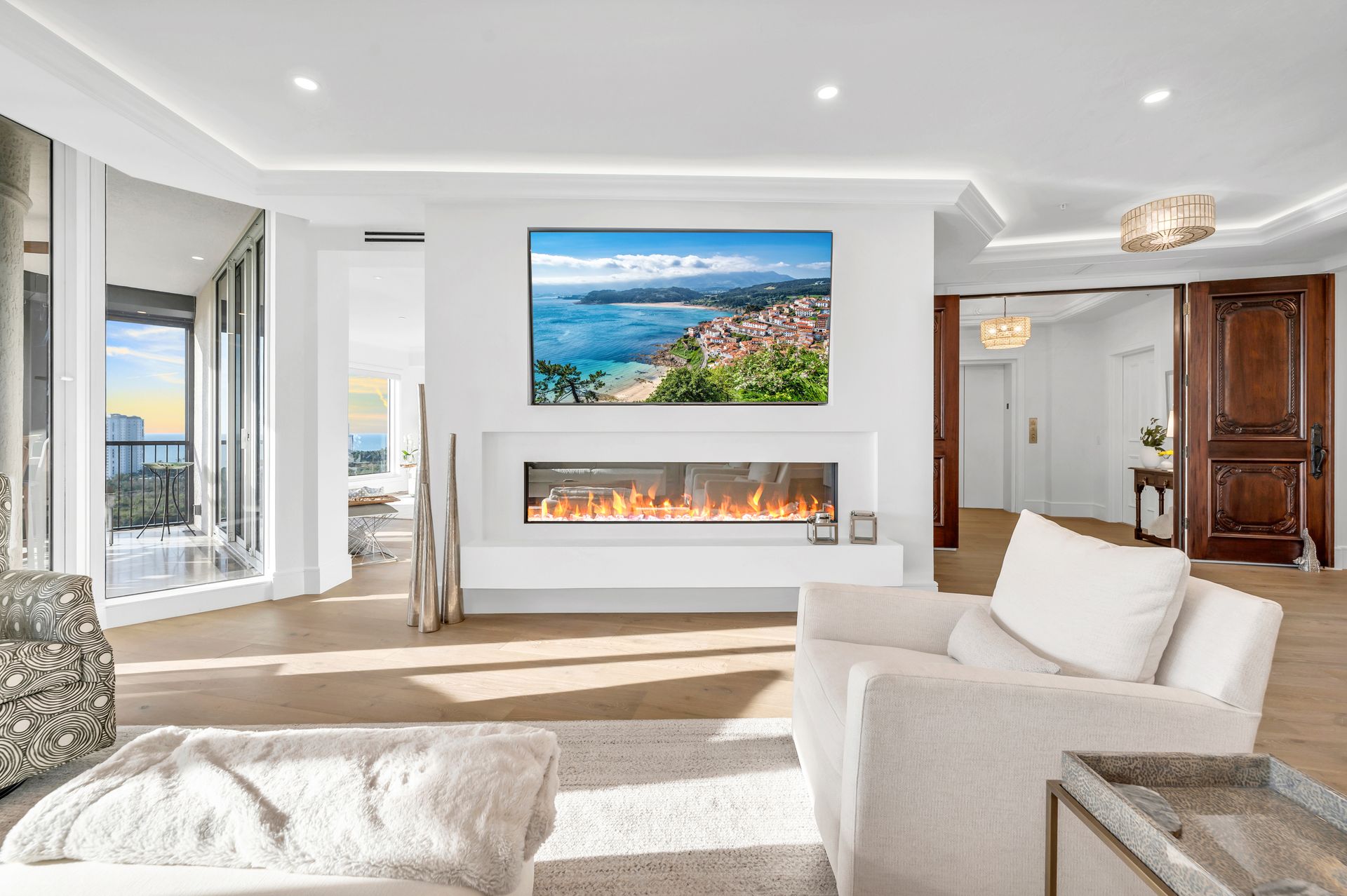 A living room with a fireplace and a flat screen tv on the wall.