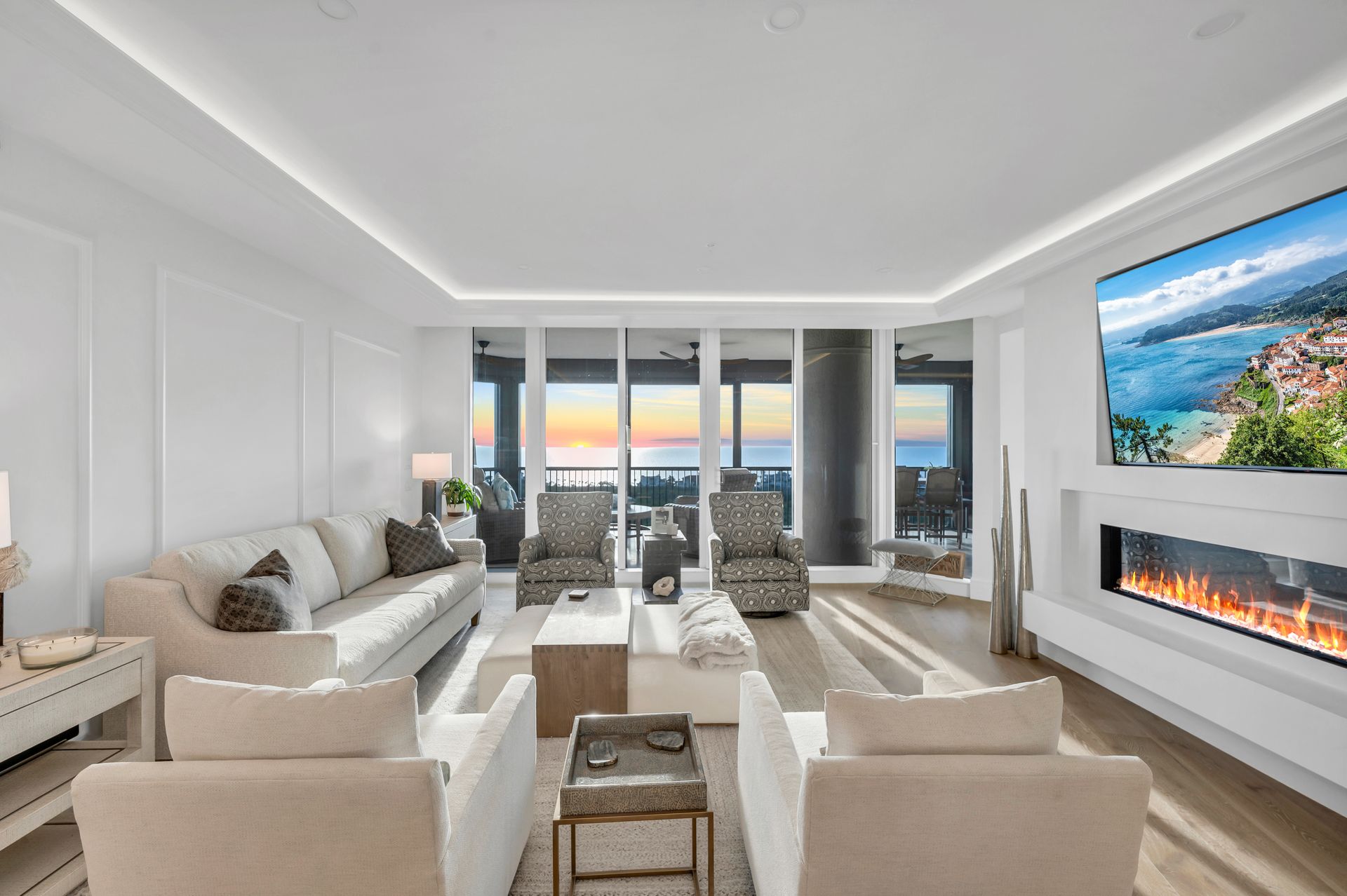 a living room with a couch , chairs , and a fireplace .