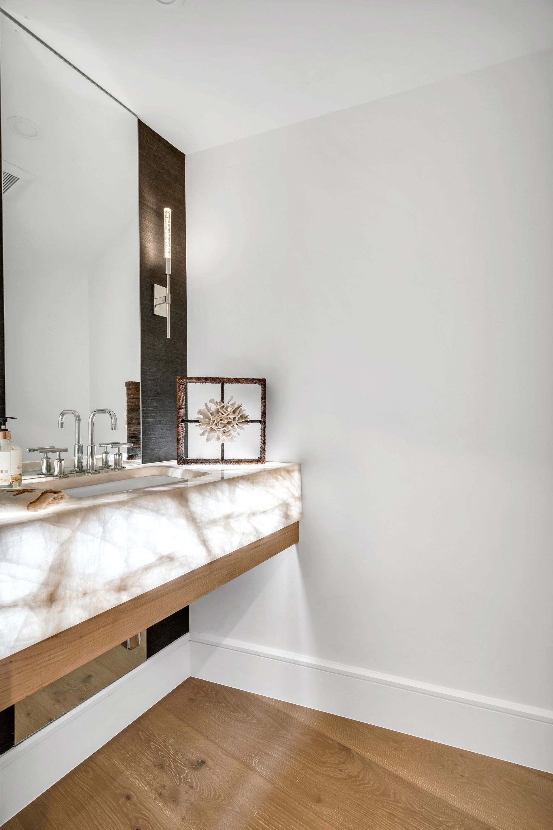 a bathroom with a sink and a large mirror