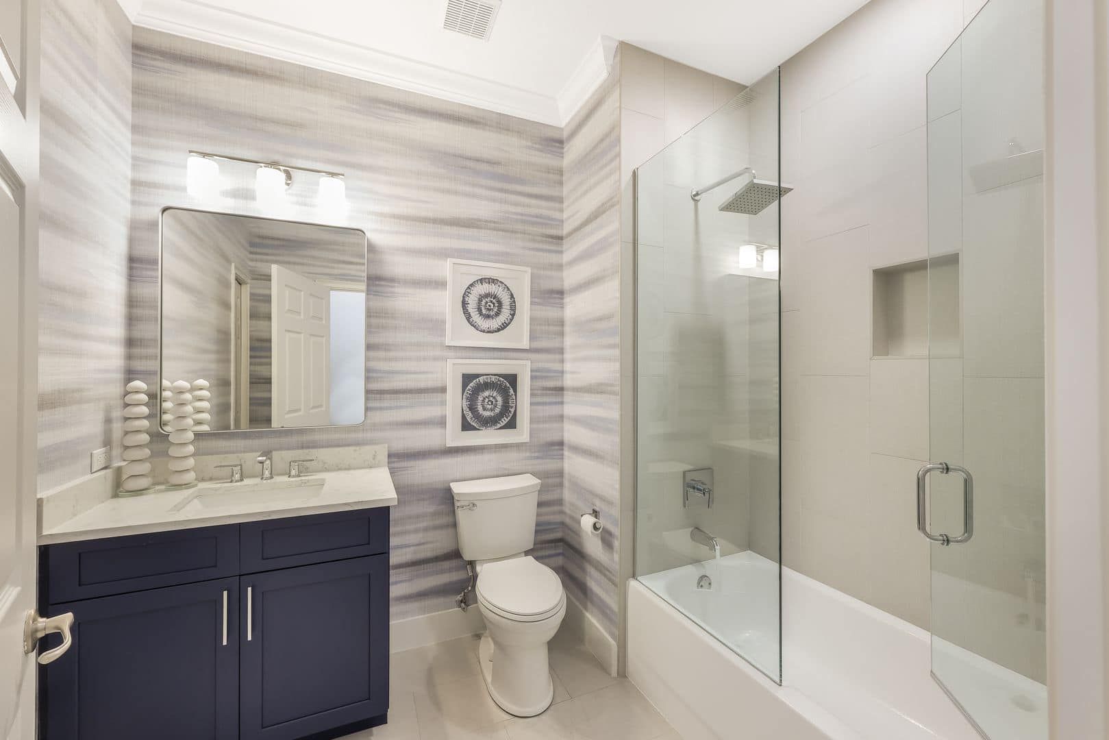 A bathroom with a toilet , sink , shower and bathtub.