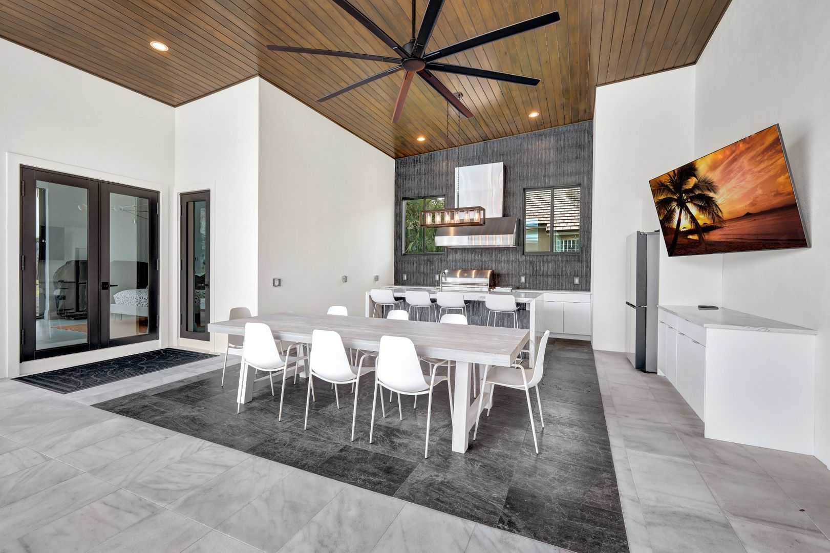 a large room with a table and chairs and a ceiling fan