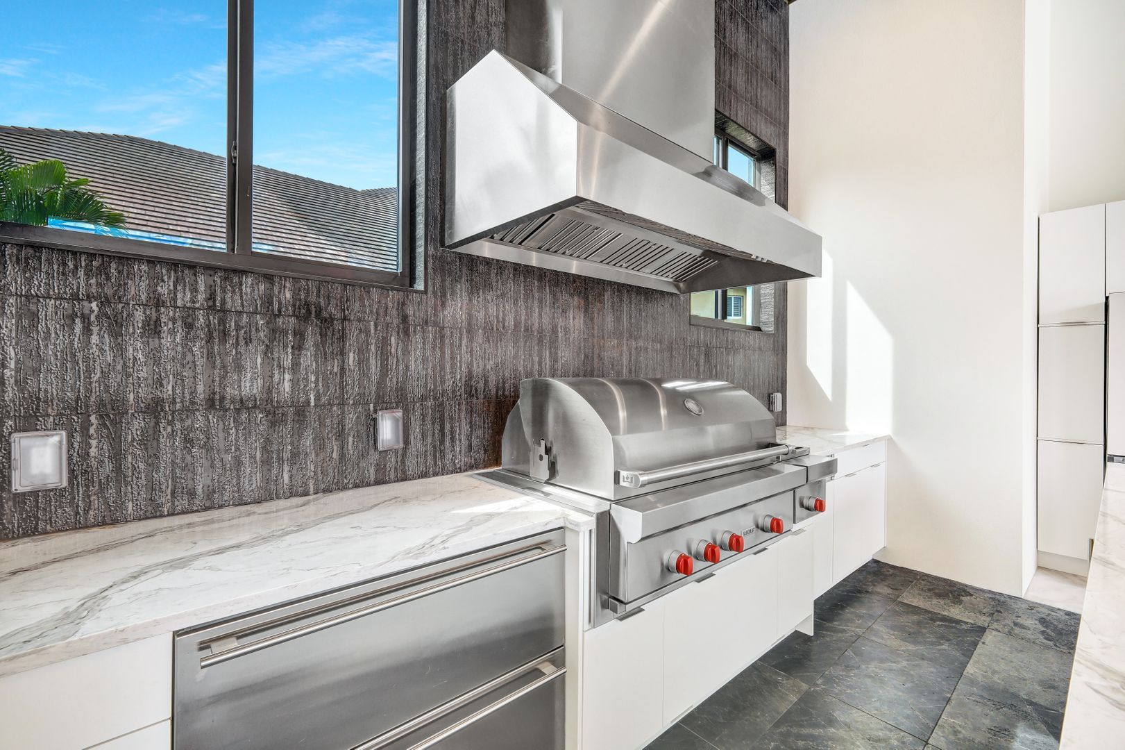 a kitchen with a stainless steel grill and a window .