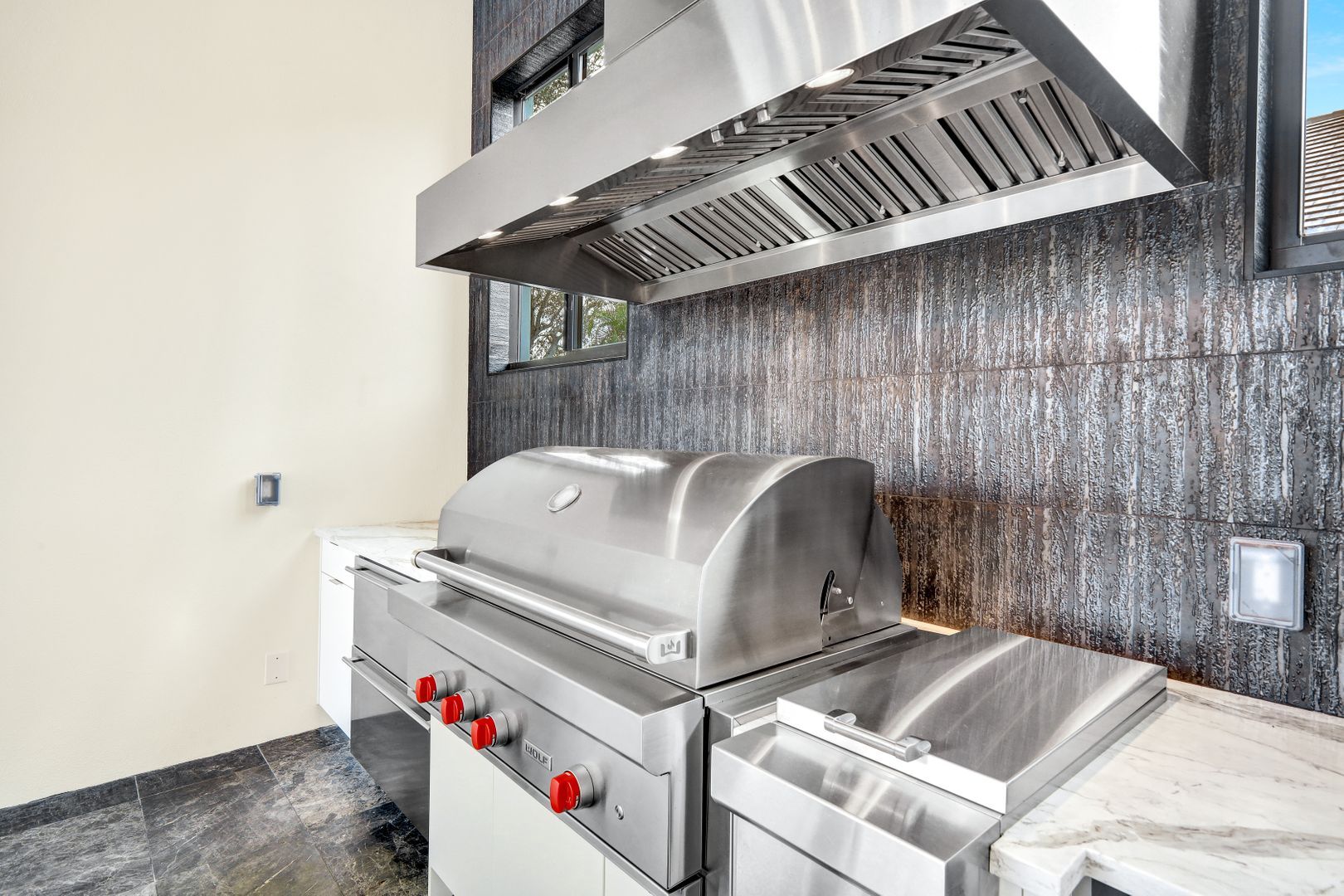 a stainless steel grill is sitting on a counter in a kitchen .