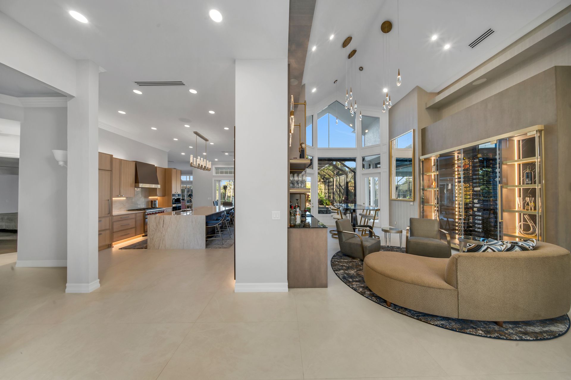 A living room with a couch , chairs , and a wine cellar.