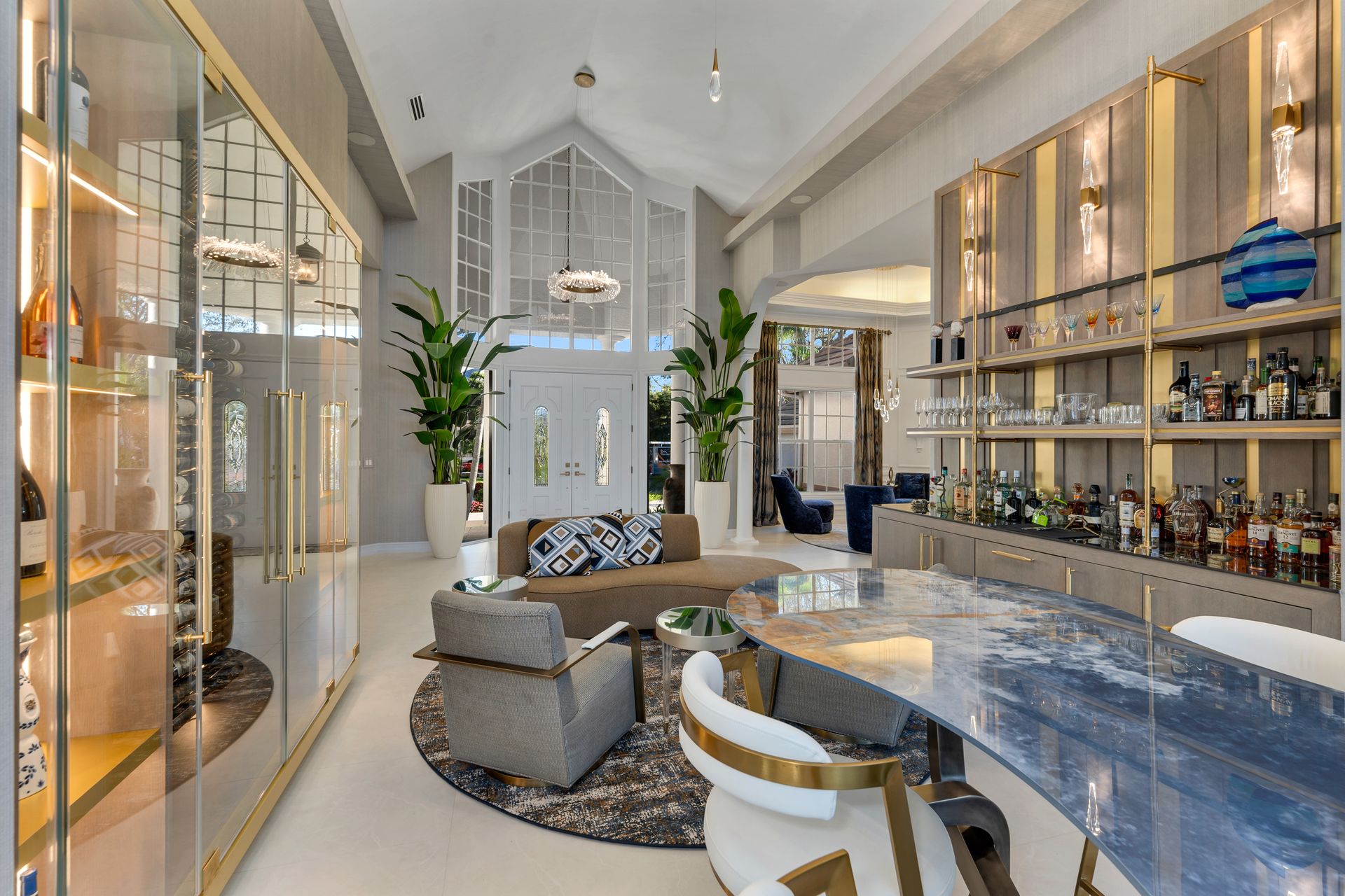 A living room with a couch , chairs , and a bar.