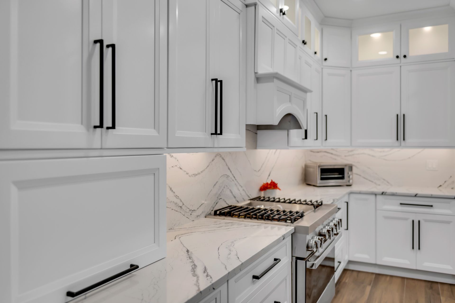 A kitchen with white cabinets and stainless steel appliances.