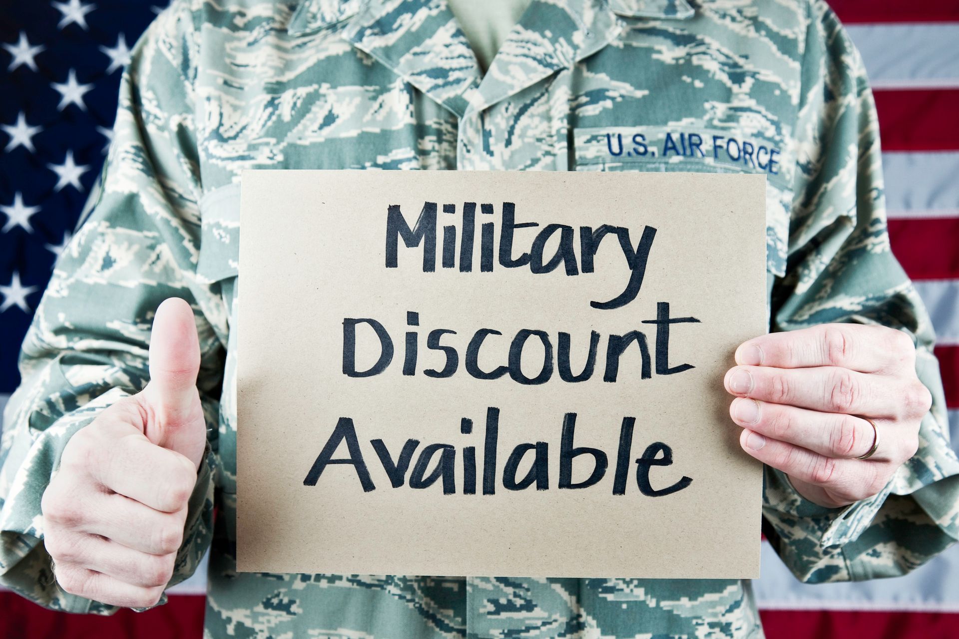Air Force member holding a sign,