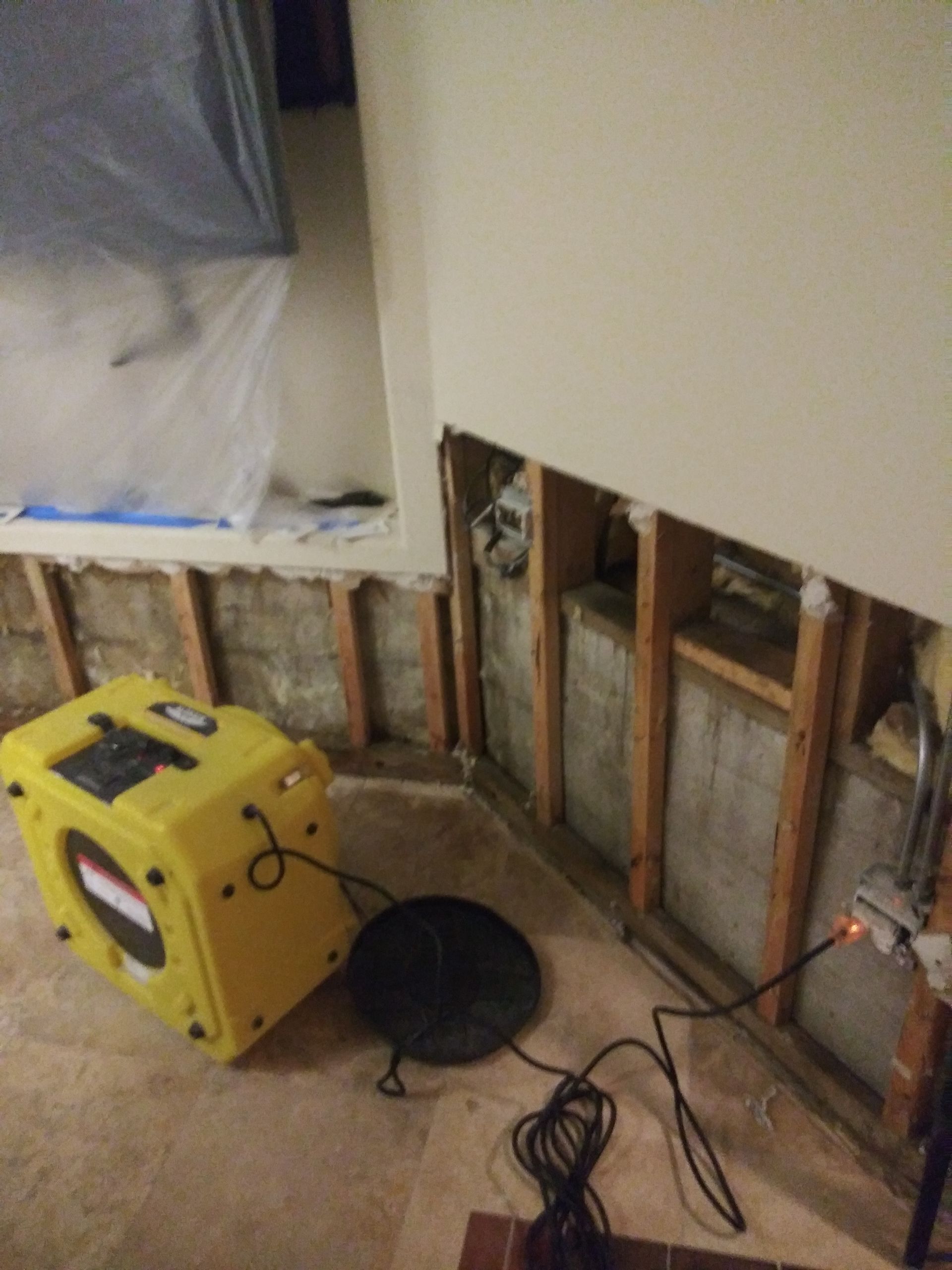 A yellow box is sitting on the floor next to a wall