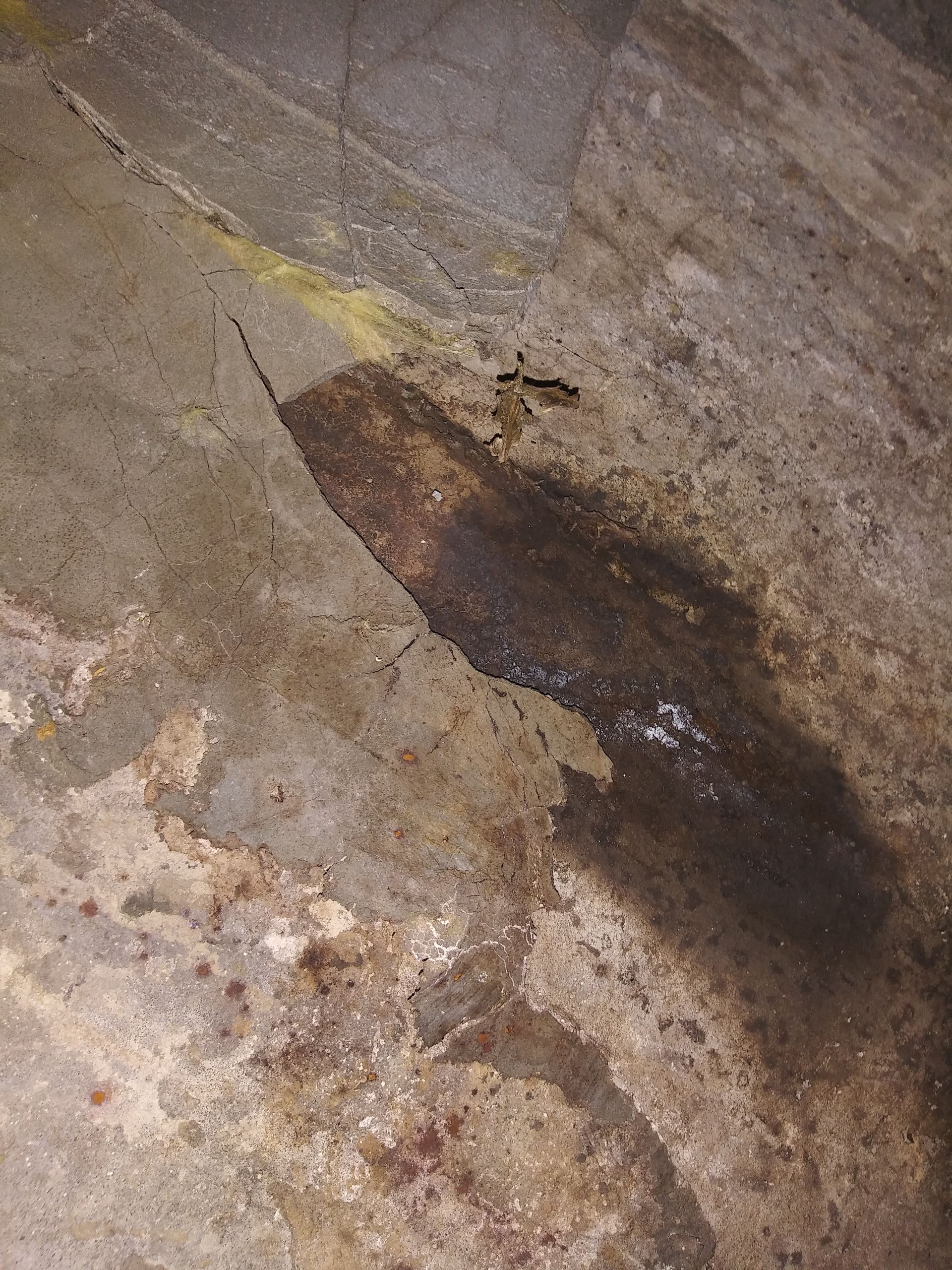 A close up of a concrete floor with a stain on it.