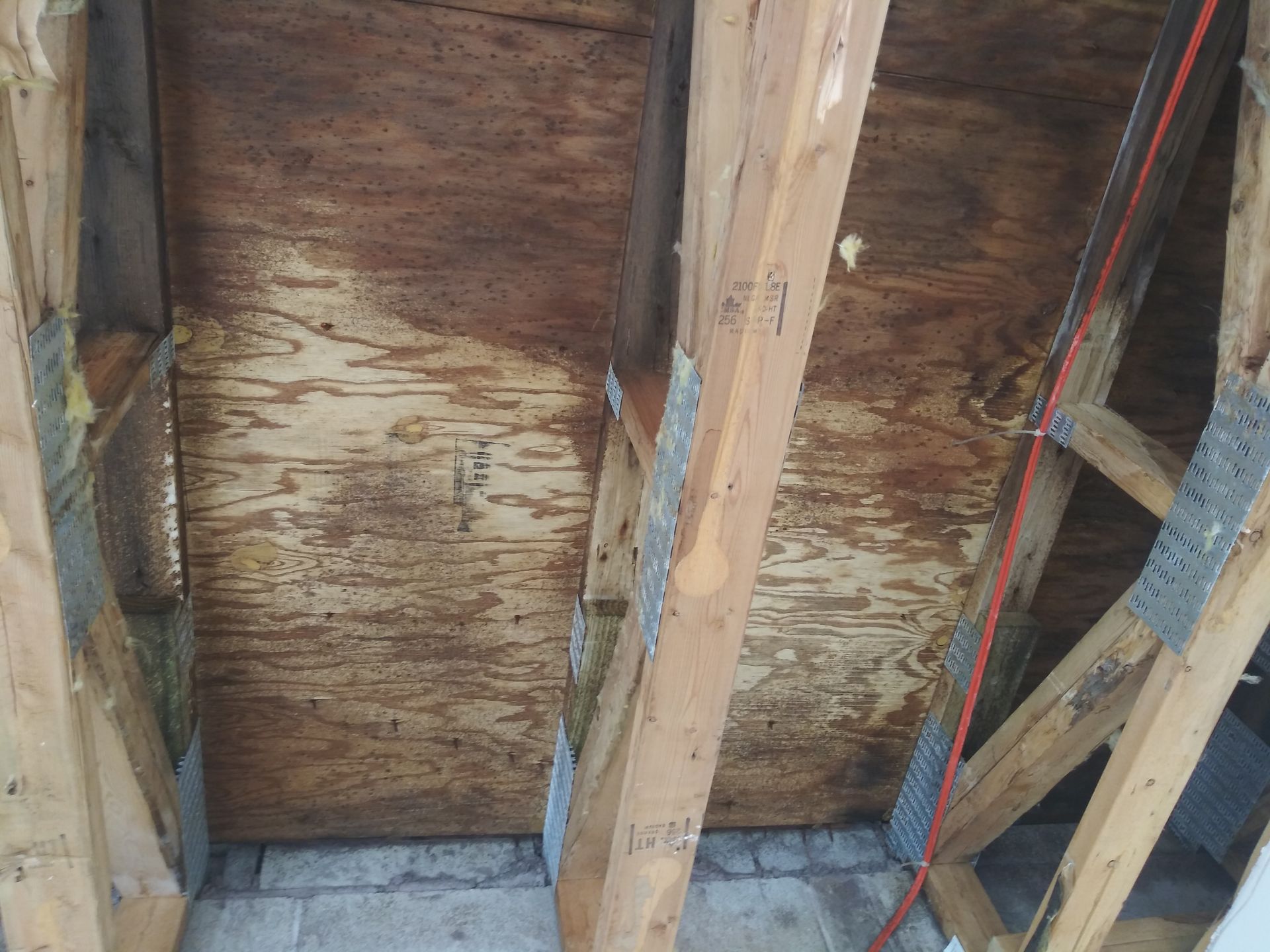 A wooden structure with a red cord hanging from it.